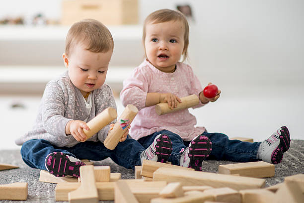 istock Twin sisters playing together in preschool. 507632152