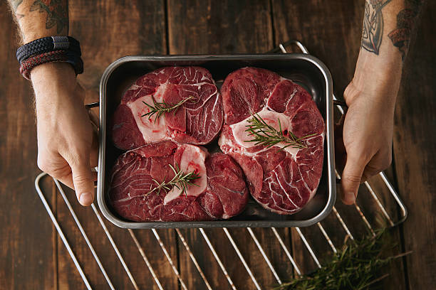 istock top view two hands offer  meat steaks in pan 507633206
