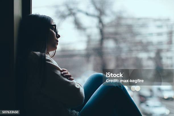 Teenage Girl Looking Out The Window Stock Photo - Download Image Now - Sadness, Depression - Sadness, Teenager