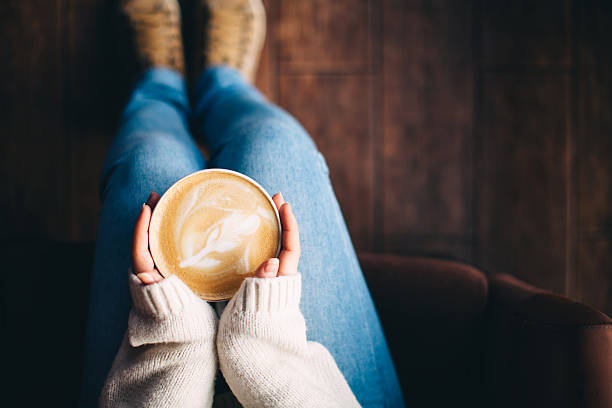 Girl's hands holding a cup of coffee