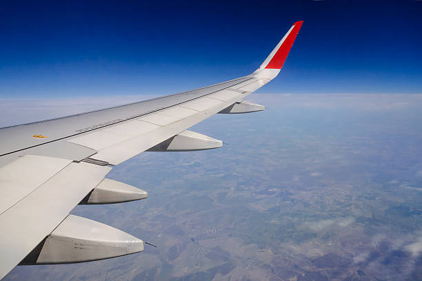 istock Wing of an airplane flying 507633802