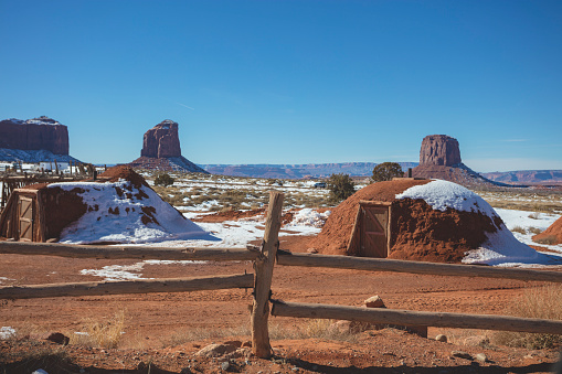 Monument Valley, USA - January 27, 2016: An editorial stock photograph of HOGAN: Diné (Navajo) Traditional House. The hogan is a sacred home for the Diné (Navajo) people who practice traditional religion. Every family -- even if they live most of the time in a newer home -- must have the traditional hogan for ceremonies, and to keep themselves in balance. 