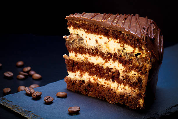 istock Chocolate cake on slate plate on black background 507634704