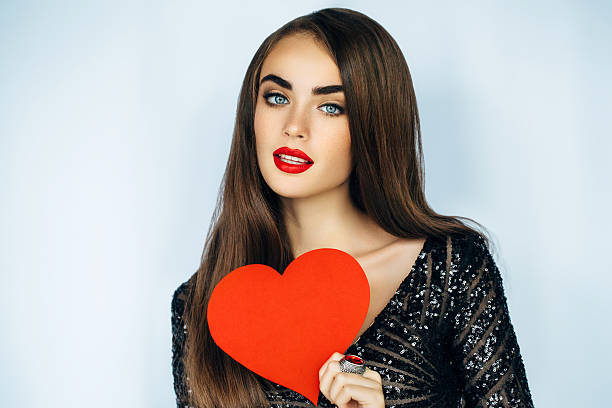 istock Beautiful woman holding artificial heart 507635570