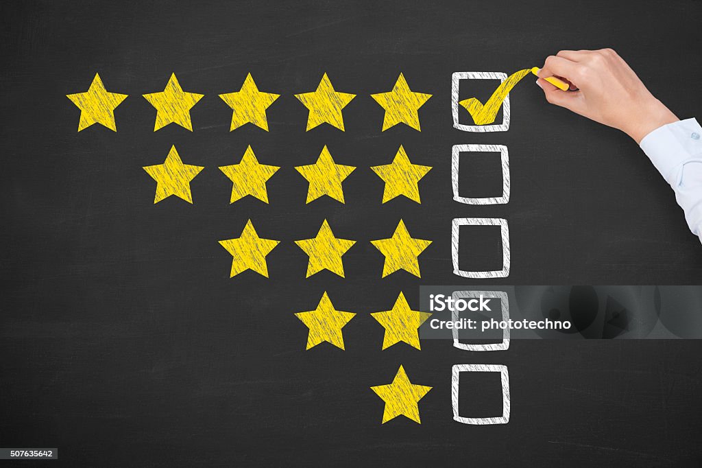 Rating Five Golden Stars on Blackboard Luxury Hotel Stock Photo