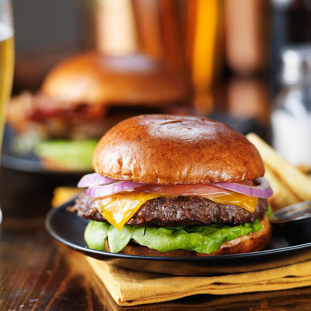 istock cheeseburgers and fries on table top 507636950