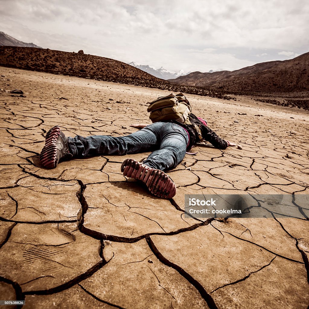 person lays on the dried ground traveller lays on the dried ground Thirsty Stock Photo