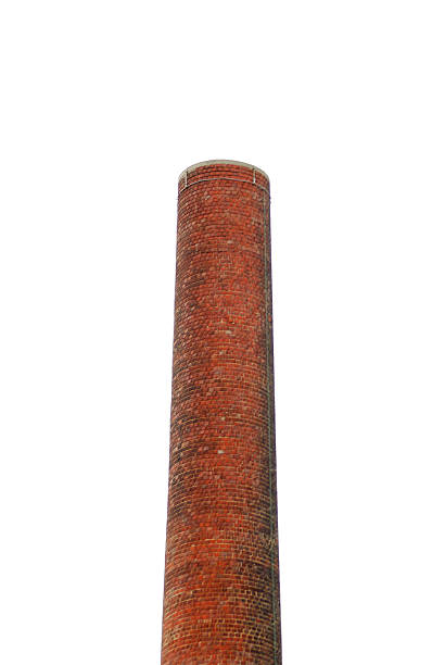 istock Brick smokestack rises into the sky to expel smoke 507640246