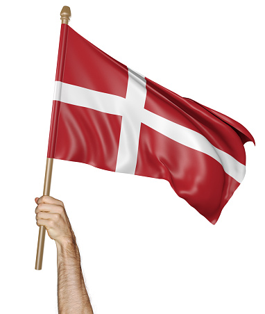 Man's hand raising the Danish national flag high in the air, isolated against a white background.