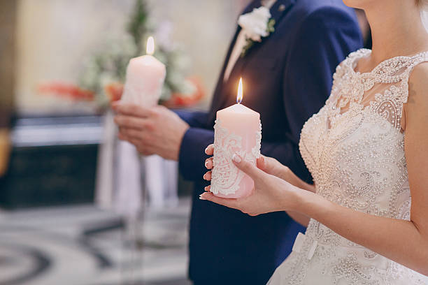 istock hands candle church wedding 507641488