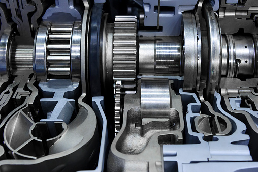 Gearbox cross-section, engine industry, sprockets, cogwheels and bearings of automotive transmission for oversize trucks, SUV, cargo, commercial and construction vehicles, selective focus 