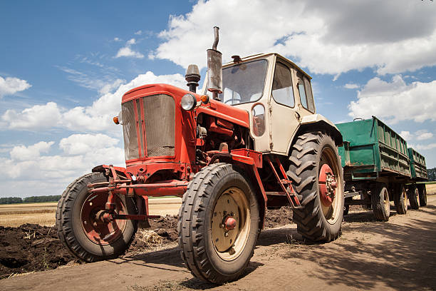 istock old tractor in field, against a cloudy sky 507650953