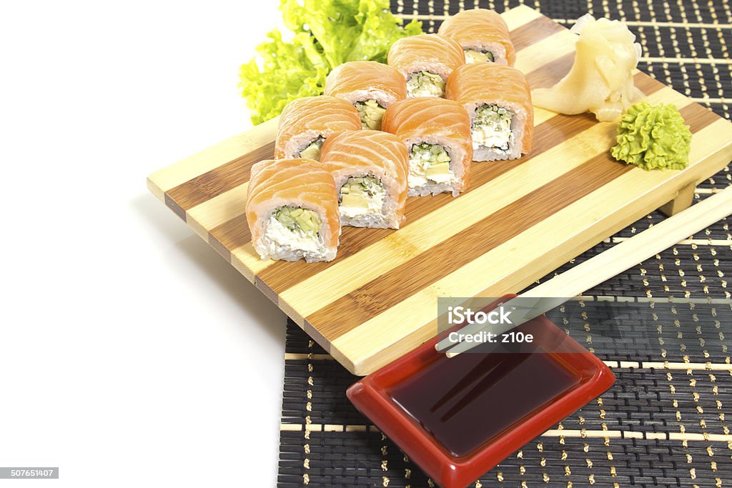 Sushi roll on a plate isolated on white background Appetizer Stock Photo