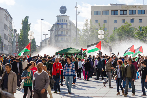 Munich, Germany - August 16, 2014: Pacific meeting against the rights infringement of the Palestinian population in Gaza, occupied of Israeli military forces. Activists with flags and slogans call for independence and freedom.