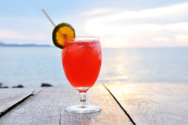 istock Cocktail drink with orange slice garnish on old wooden table 507651611