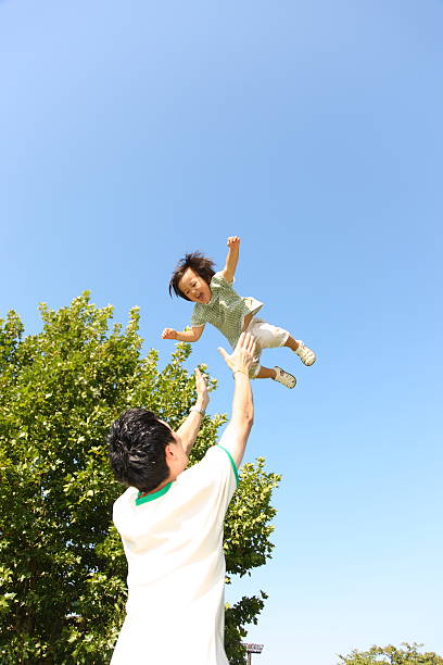 istock father throws daughter in air 507652493
