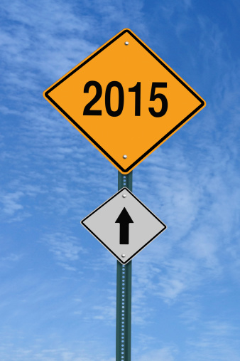 2015 ahead road sign over blue sky with clouds