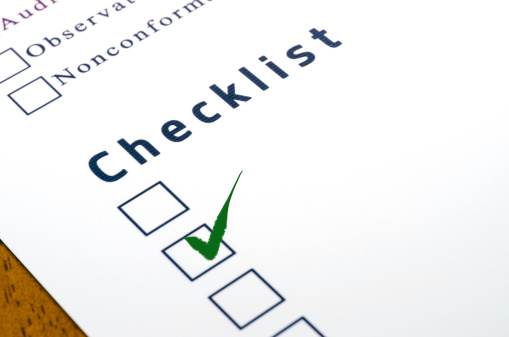 checklist with a ticked box on white paper