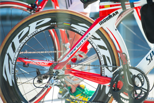 Florianópolis, Santa Catarina, Brasil - May 24, 2014: Ironman racing bicycle close-up at the check-in start point with a competitor in the background during the Ironman competition.