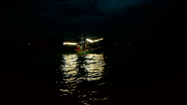 Fishing boat in the sea at night