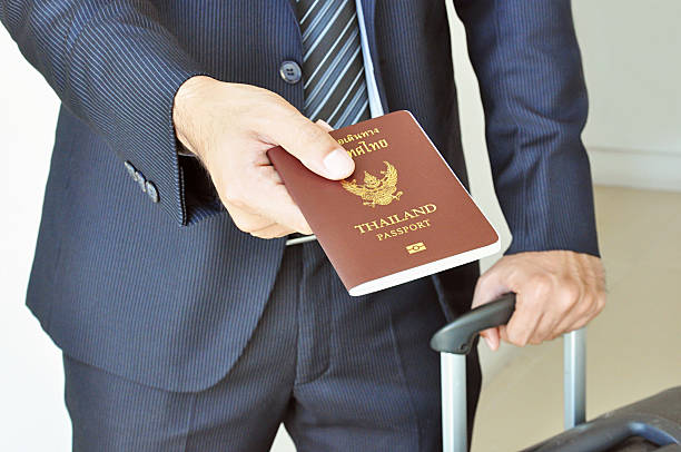 istock Businessman hand giving passport 507654015