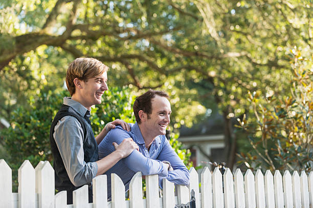 istock Gay couple standing in front yard 507654017