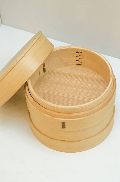 istock Bamboo basket steamer with open lid isolated on white 507654265