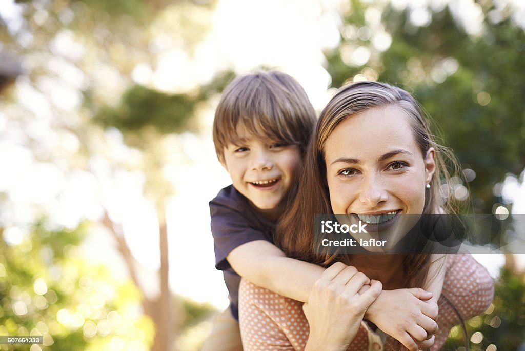 Horsing around with Mom Portrait of a happy young mother carrying her son on her backhttp://195.154.178.81/DATA/istock_collage/0/shoots/784515.jpg Mother Stock Photo