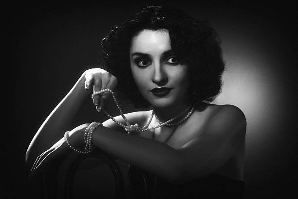 1940s style photo. Female portrait Black and white Retro-styled photo in 1940s style. Grain and some effects added for more deep and natural vintage effect. film noir style photos stock pictures, royalty-free photos & images