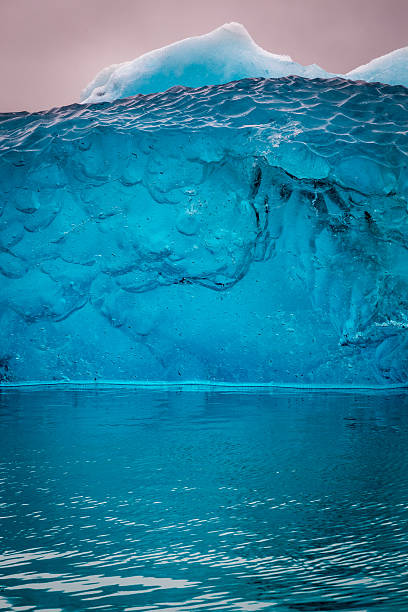 Blue iceberg just after flipping in water, Iceland