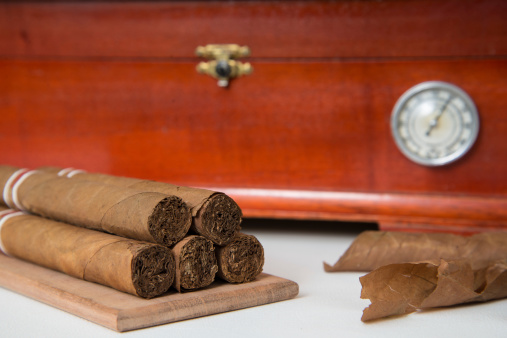 Cuban cigars and wooden humidifier on a white background