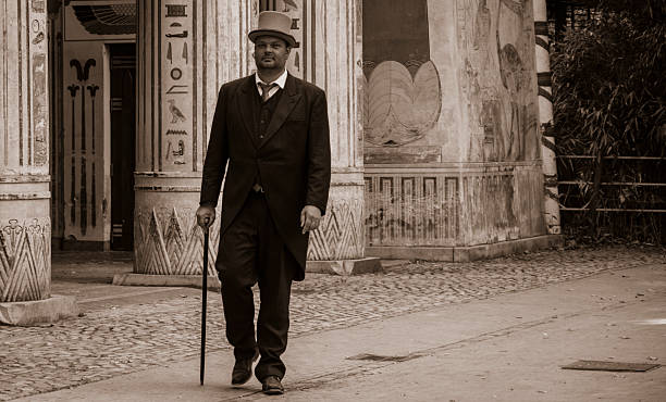 Top has BW gentleman A gentleman in coats and top hat, walking past an 1830s  temple, self portrait edwardian style photos stock pictures, royalty-free photos & images