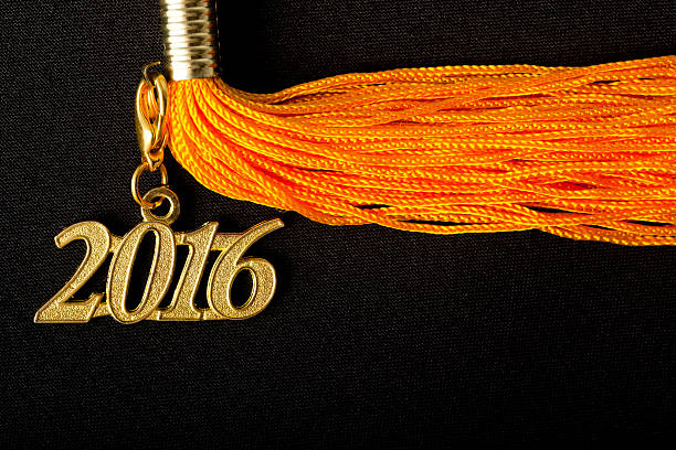 istock Yellow Tassel with 2016 pendant on black graduation hat 507684850