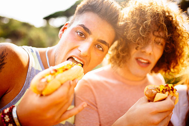 istock Guys Eating Hotdogs 507684943