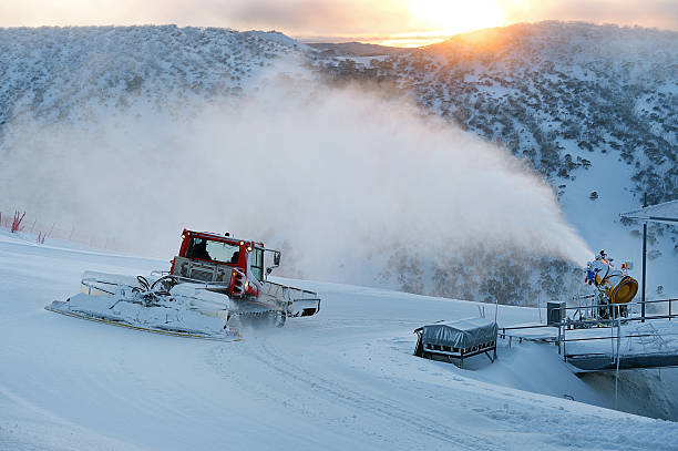 Snow Groomer and Snowmaking at Dawn stock photo