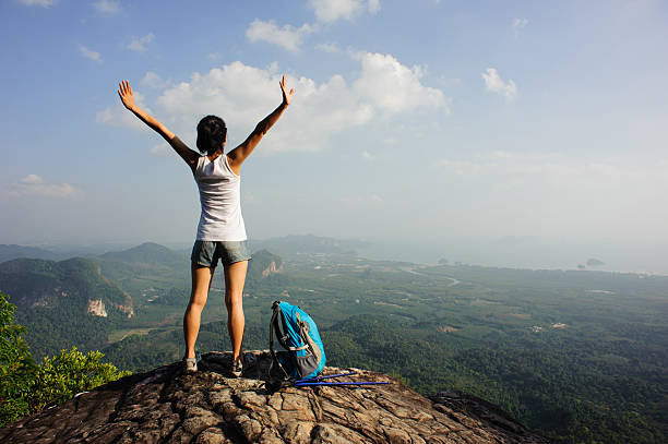 istock woman hiker enjoy the view on mountain peak cliff 507685148