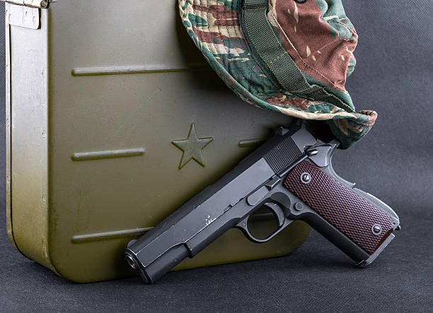 Box for bullets, a gun and a camouflaged hat