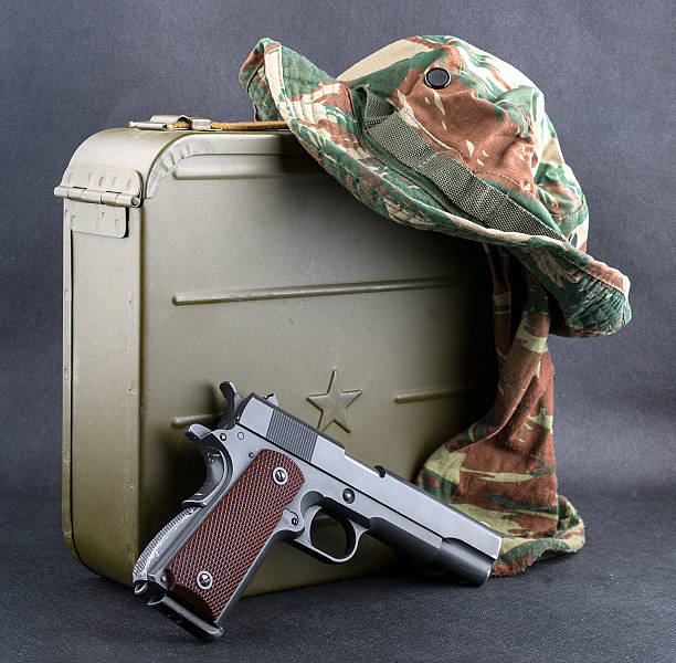 istock Box for bullets, a gun and a camouflaged hat. 507685922