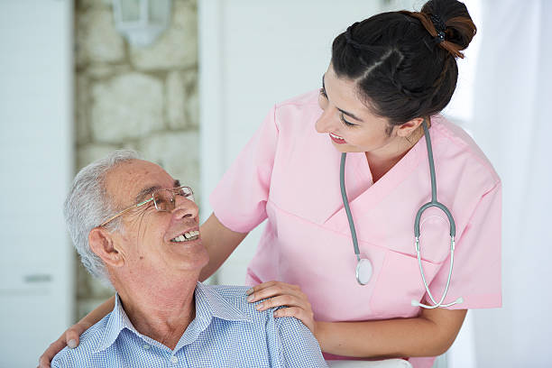 istock Female nurse with old man 507686244