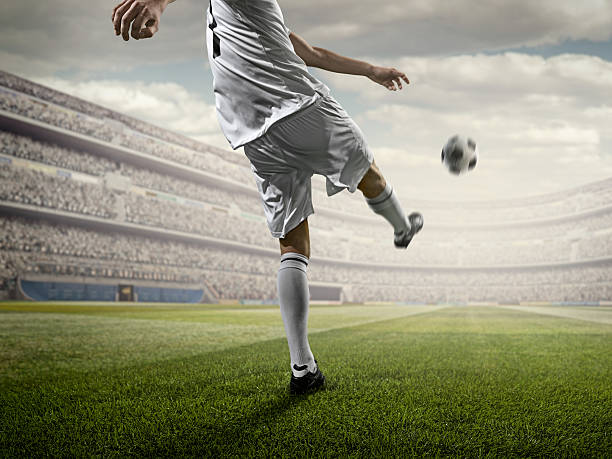 istock Soccer player kicking ball in stadium 507687128