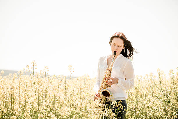istock Woman playing saxophone in nature 507688040