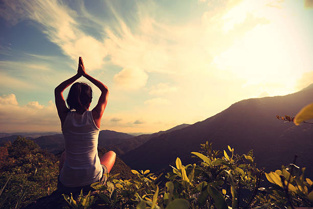 istock yoga woman practice on mountain peak 507688218