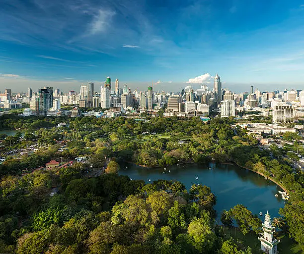 Lumphini Park and the downtown Bangkok City Skyline Thailand