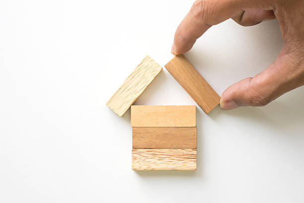 istock Hand arranging wood block as house. 507689458