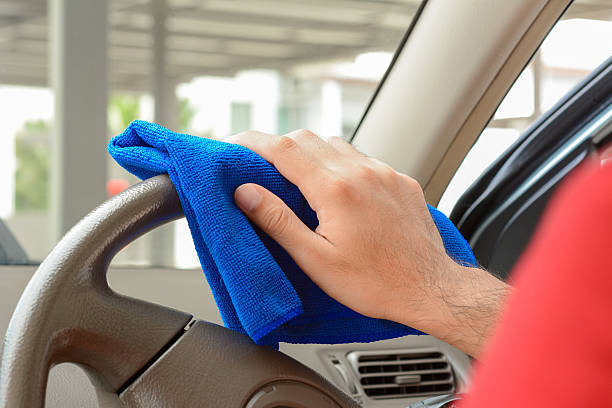 istock Hand cleaning car steering wheel with microfiber cloth 507690172