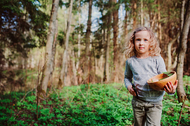 istock child girl exploring nature in early spring forest 507690698
