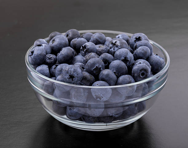 istock ripe blueberries in bowl on black 507693222