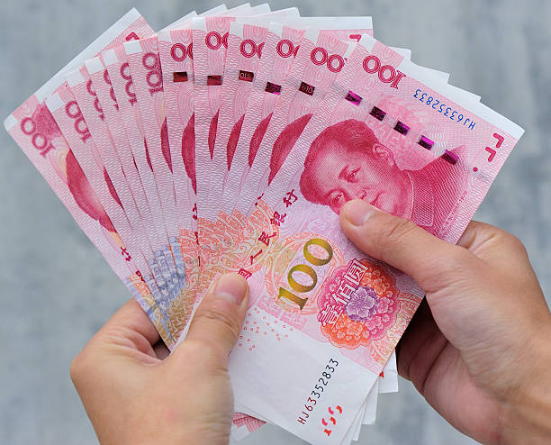 istock Hands with chinese yuan money 507705050