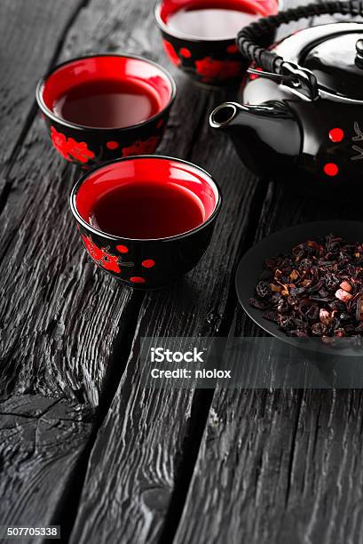 Cups Of Tea And Teapot On Black Wooden Table Stock Photo - Download Image Now - Backgrounds, Black Color, Bowl