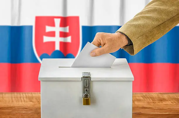 Man putting a ballot into a voting box - Slovakia